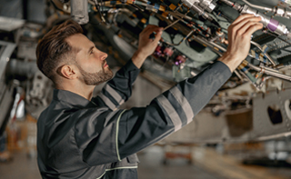 mechanic inspecting private charter jet landing gear in New Jersey